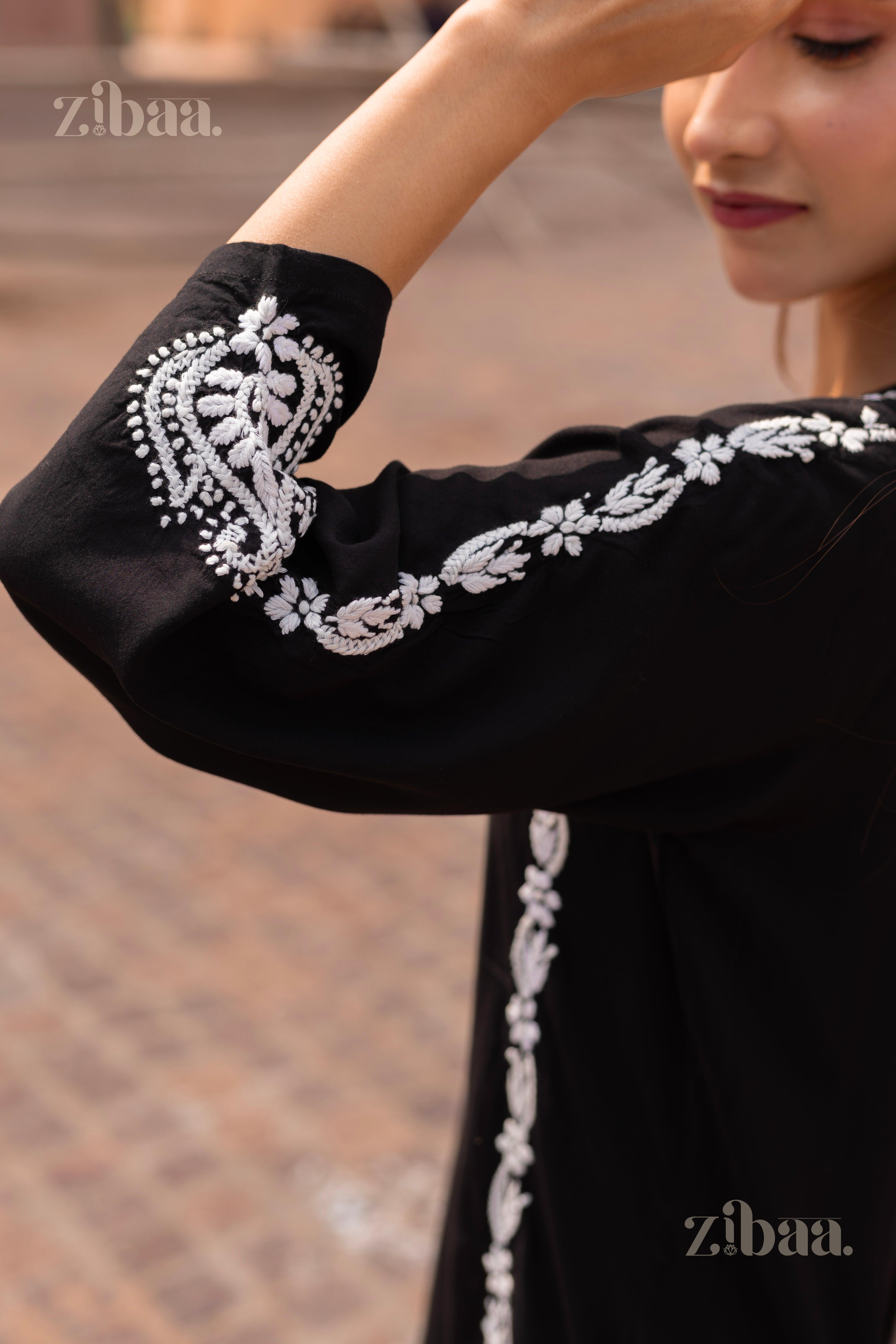 Close-up of a Black Kurti showing intricate white embroidery on the sleeve, highlighting traditional craftsmanship in an elegant style