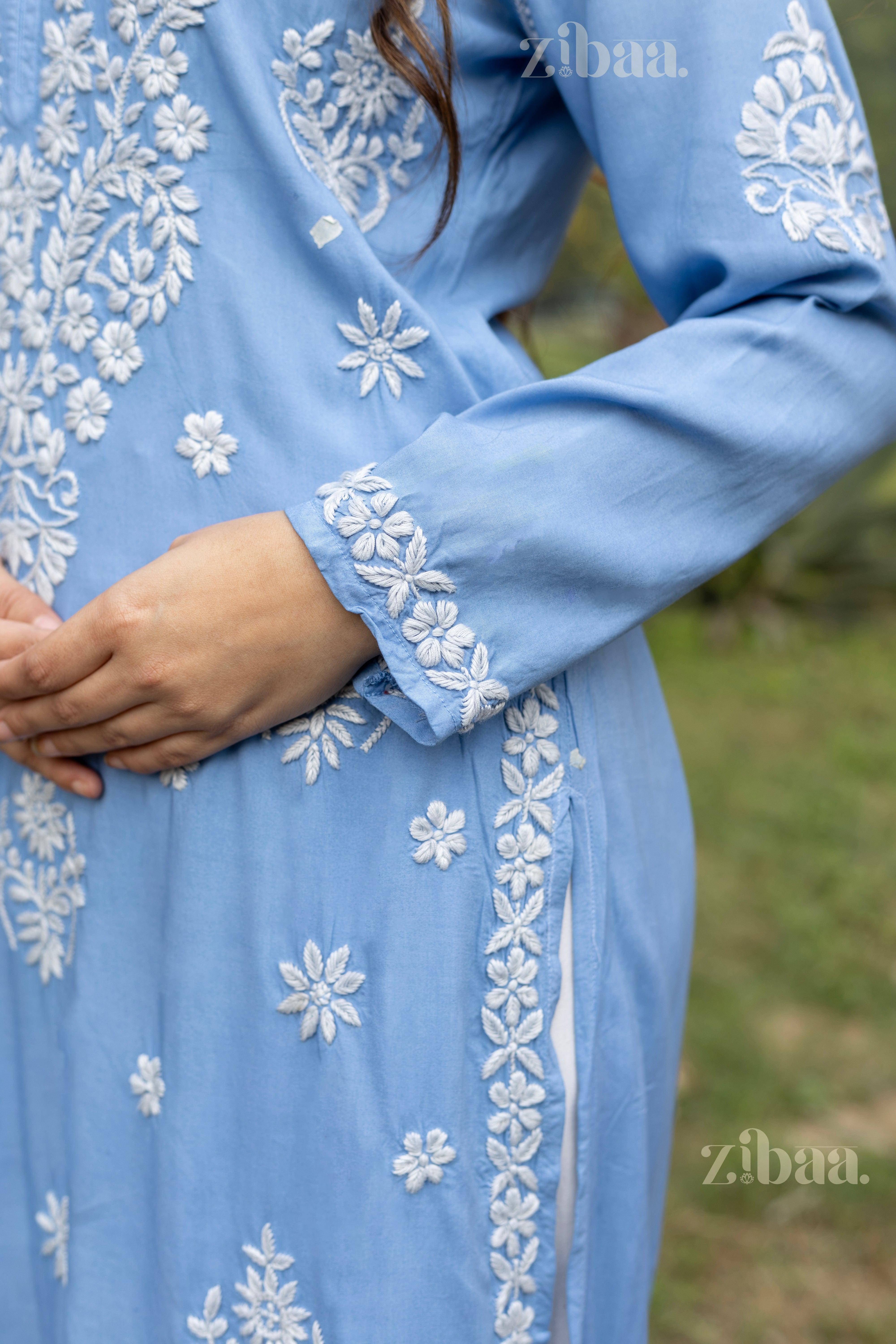 Close-up of blue Lucknowi Kurti showing intricate white embroidery on sleeves and sides highlighted traditional craftsmanship.